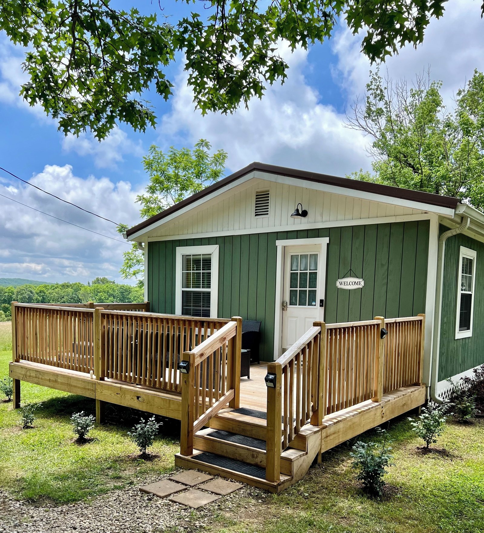 Green Sweet Pea Cottage with a covered front porch