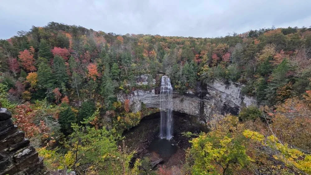 Fall Creek Falls framed by autumn foliage from an overlook